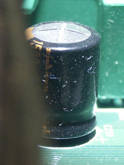 Image for Old mainboard: Closeup of broken cap